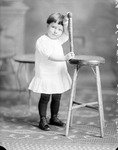 Box 35, Neg. No. 36009: Girl Standing Next to a Chair