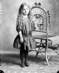 Box 35, Neg. No. 37089: Girl Standing Next to a Chair