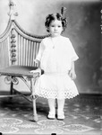 Box 36, Neg. No. 39154: Girl Standing Next to a Chair