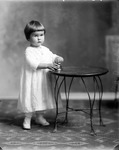 Box 36, Neg. No. 39305: Girl Standing at a Table