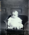 Box 38, Neg. No. 57632B: Baby Sitting in a Chair