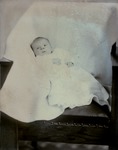 Box 38, Neg. No. 39724B: Baby Lying in a Chair