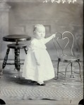 Box 39, Neg. No. 39987: Baby Standing Between Two Chairs