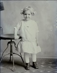 Box 39, Neg. No. 37073: Girl Standing at a Table