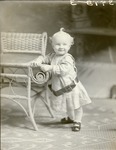 Box 39, Neg. No. 39983: Baby Standing Next to a Chair