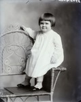 Box 39, Neg. No. 37054C: Girl Sitting on the Arm of a Chair
