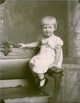 Box 40, Neg. No. 52803-R: Girl Sitting on the Arm of a Chair