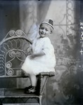 Box 40, Neg. No. 52852: Girl Sitting on the Arm of a Chair