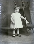 Box 41, Neg. No. 52829: Girl Standing Next to a Chair