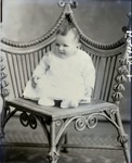 Box 43, Neg. No. 52478: Baby Sitting on a Chair