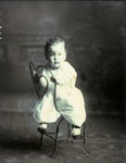 Box 44, Neg. No. 52394: Baby Sitting Backwards on a Chair