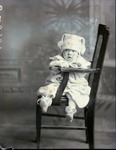 Box 44, Neg. No. 52890:  Baby Sitting Sideways on a Chair