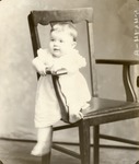 Box 46, Neg. No. 54514-B: Baby Sitting Sideways on a Chair