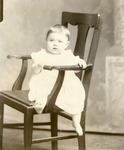 Box 46, Neg. No. 54514-C: Baby Sitting Sideways on a Chair