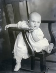 Box 46, Neg. No. 54414-RB: Baby Sitting Sideways on a Chair