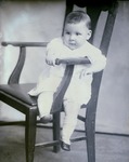 Box 46, Neg. No. 54456: Baby Sitting Sideways on a Chair