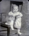 Box 46, Neg. No. 52584: Baby Sitting on a Chair