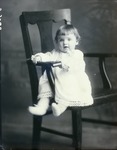 Box 47, Neg. No. 53066: Baby Sitting Sideways on a Chair