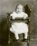 Box 47, Neg. No. 53086-R: Baby Sitting Sideways in a Chair