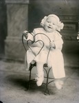 Box 47, Neg. No. 53059: Baby Sitting Backwards on a Chair