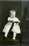 Box 48, Neg. No. 53288: Baby Sitting Sideways on a Chair