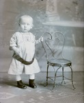 Box 54, Neg. No. 40767: Toddler Standing Next to a Chair