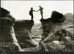 048-01: 51-21 Paleontologists Reaching Between Two Rock Faces, Shaking Hands by George Fryer Sternberg 1883-1969