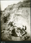 056-02: 59-21 Three Men Excavating Fossilized Dinosaur Bones by George Fryer Sternberg 1883-1969