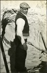 028_05: A Man Standing Near a Rock Wall