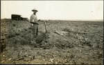 065_03: Man Standing Next to a Pile of Dirt by George Fryer Sternberg 1883-1969