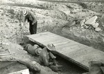 Three Men at an Excavation Site