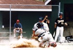 Baseball Catcher and Player Sliding into Base by Fort Hays State University Athletics