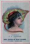 Postcard: Compliments of J. A. Johnson Fine Jewelry, Spectacles and Musical Instruments, Brunette Woman