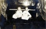 Postcard: Portrait of Two Infants Sitting on a Piano Bench