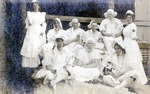 Postcard: Portrait of Nurses with Men Dressed Up in Baby and Women's Clothing