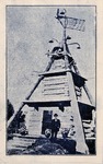 Postcard: S. P. Dinsmoor Standing in Front of Mausoleum at Garden of Eden with White Border