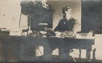 Postcard: Man Sitting at a Desk