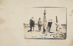 Postcard: Man and Children Standing Next to Dugout