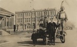 Postcard: Man Standing in a Float in Front of the Great Bend Hotel