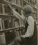 Woman Reaching For A Book In Forsyth Library