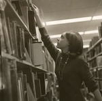 Woman Reaching For A Book In Forsyth Library