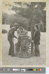 Four Students Standing with Two Wagon Wheels