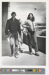 Black-and-White Photograph of Two Women and One Man Walking on Campus