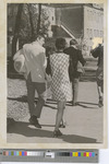 Black-and-White Photograph of a Group of Students Walking on Campus