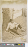 Man Sitting Against a Tree While Gazing into the Distance