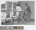 A Couple Playing Pinball in the Union Basement