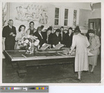 Ten People Standing Around a Table Looking at Scrapbooks 1950s
