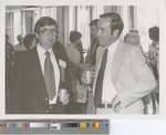 Two Men Interacting at the 1977 75th Anniversary Exhibition
